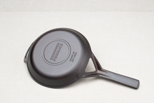 Load image into Gallery viewer, Underside of Borough Furnace 9-inch cast iron skillet showing stay cool handle and pre-seasoned surface