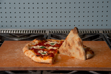 Load image into Gallery viewer, A pizza with a crisp bottom after being cooked on a Borough Furnace Pizza Griddle.
