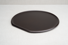 Load image into Gallery viewer, A black cast iron pizza griddle with a flat edge, displayed on a light background.
