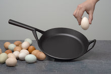 Load image into Gallery viewer, Borough Furnace 10.5" skillet with heritage eggs and hand for scale
