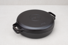 Load image into Gallery viewer, A black cast iron braising skillet with a paired lid, featuring large handles on the sides.
