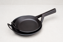 Load image into Gallery viewer, Borough Furnace 9-inch and 10.5-inch cast iron skillets stacked together for size comparison
