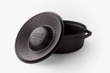 Load image into Gallery viewer, Seasoned cast iron dutch oven showing loop handles and basting pips on the underside of the lid
