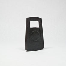 Load image into Gallery viewer, A black cast iron bottle opener standing upright on a white background.
